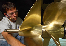 a cruisers fabricator inspecting a propeller blade