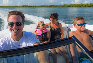 Family on boat cruising through water