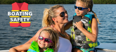 Mom with kids wearing life jackets on a boat