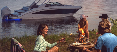 Family enjoying the fall evening with their boat in the background