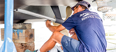 A MarineMax team member servicing a boat at Treasure Island Marina