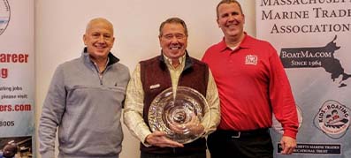 3 man standing and one holding an MMTA Industry Leader Award