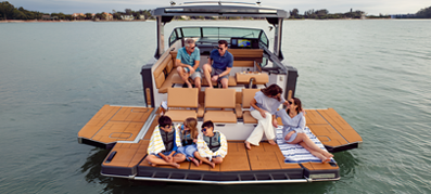 A family gathered on the swim deck of their boat