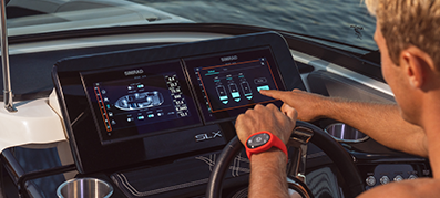 A boater viewing a modern heads up display in the cockpit of a boat