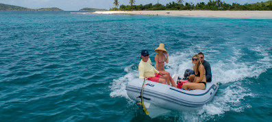 people sitting on a inflatable boat in the bvi